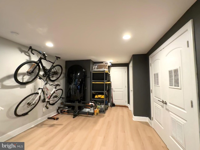 workout room with light wood-type flooring, baseboards, and recessed lighting