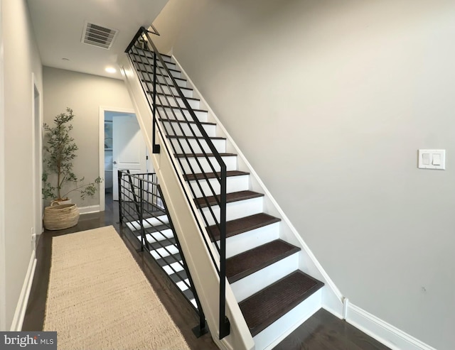 stairs featuring baseboards, wood finished floors, and recessed lighting