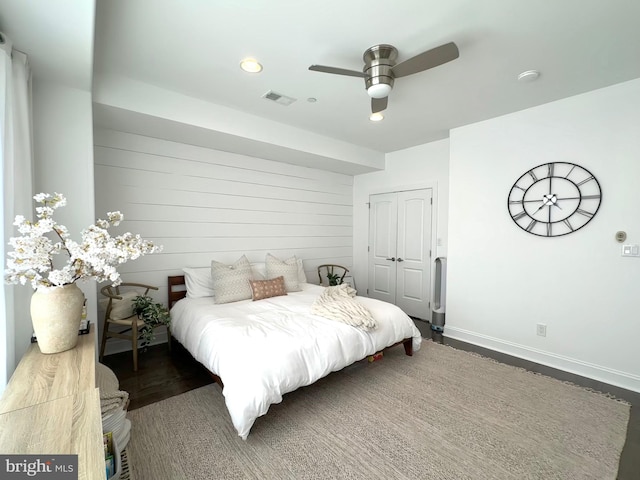 bedroom featuring a closet, recessed lighting, baseboards, wood finished floors, and a ceiling fan