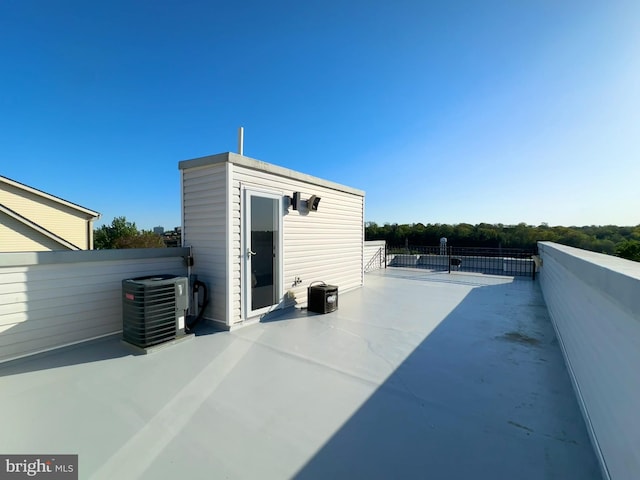 view of patio with central air condition unit and fence