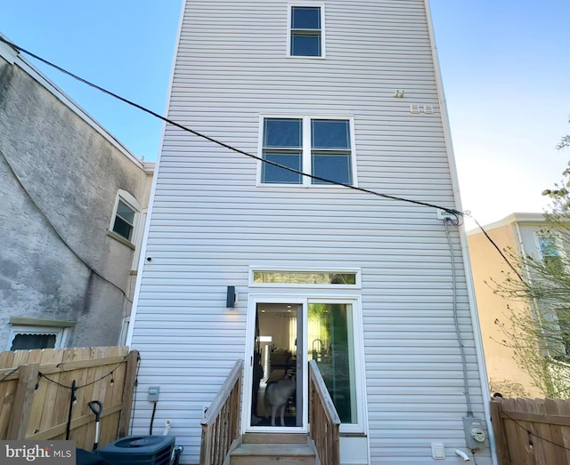 back of house with fence