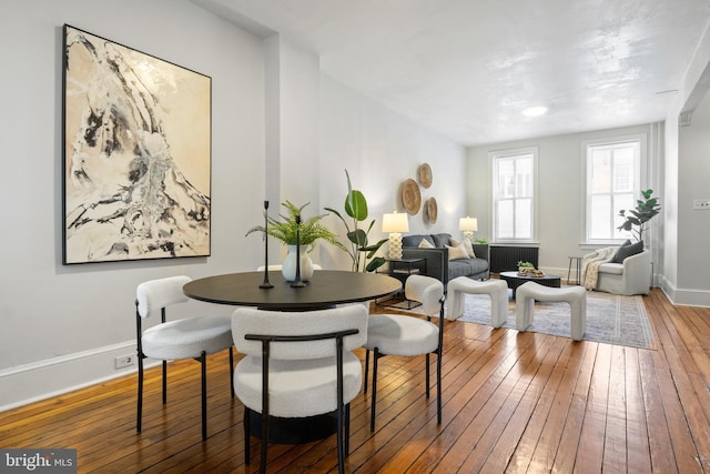 240 W Philadelphia St, York, PA 17403 - dining area featuring baseboards, hardwood / wood-style floors, and radiator heating unit