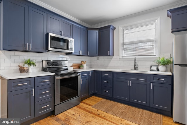 240 W Philadelphia St, York, PA 17403 - kitchen with light countertops, appliances with stainless steel finishes, ornamental molding, and a sink