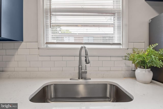 240 W Philadelphia St, York, PA 17403 - details with a sink, decorative backsplash, and light stone counters