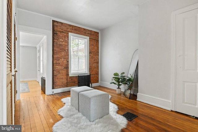 240 W Philadelphia St, York, PA 17403 - sitting room featuring brick wall, light wood finished floors, and baseboards