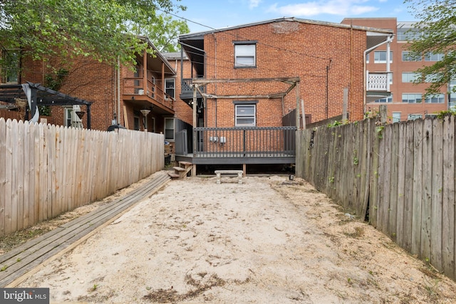240 W Philadelphia St, York, PA 17403 - back of property with brick siding, fence, and a wooden deck