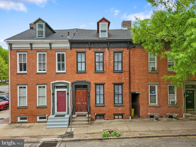 240 W Philadelphia St, York, PA 17403 - townhome / multi-family property with roof with shingles, a chimney, and brick siding