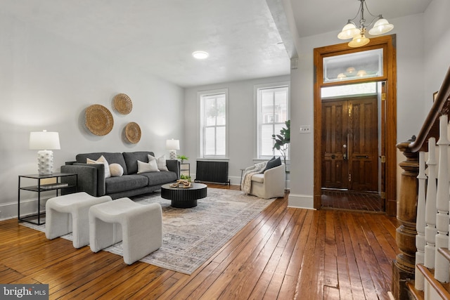 240 W Philadelphia St, York, PA 17403 - living room with an inviting chandelier, stairway, baseboards, and wood-type flooring