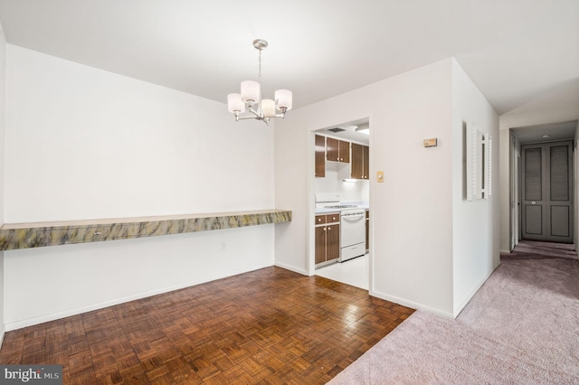 kitchen featuring gas range gas stove, a chandelier, baseboards, pendant lighting, and light countertops