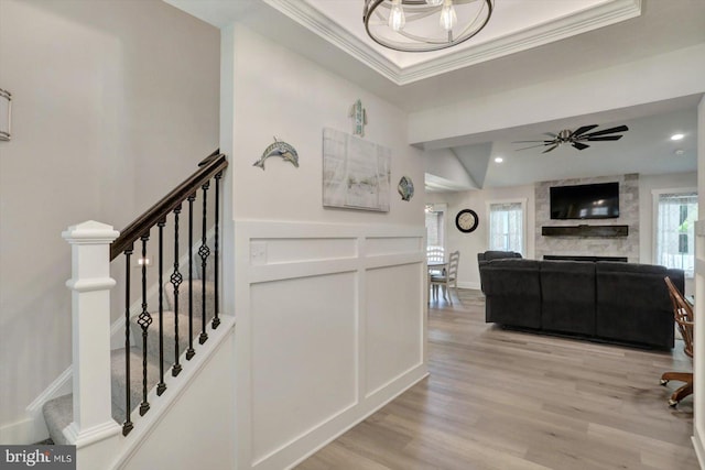 172 Charles St, Hanover, PA 17331 - staircase with a large fireplace, ornamental molding, wood finished floors, a ceiling fan, and a decorative wall