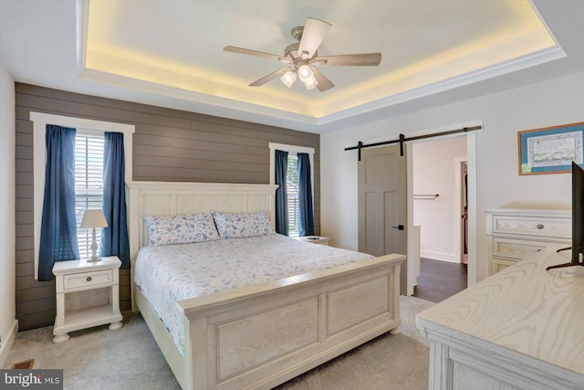 172 Charles St, Hanover, PA 17331 - bedroom featuring a tray ceiling, a barn door, multiple windows, and light colored carpet