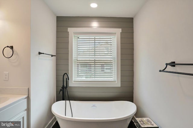 172 Charles St, Hanover, PA 17331 - full bath with a freestanding tub, vanity, wood walls, and recessed lighting