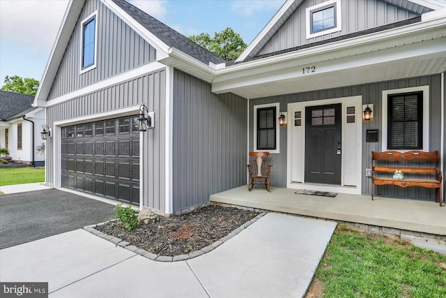 172 Charles St, Hanover, PA 17331 - entrance to property featuring a porch, driveway, a shingled roof, a garage, and board and batten siding