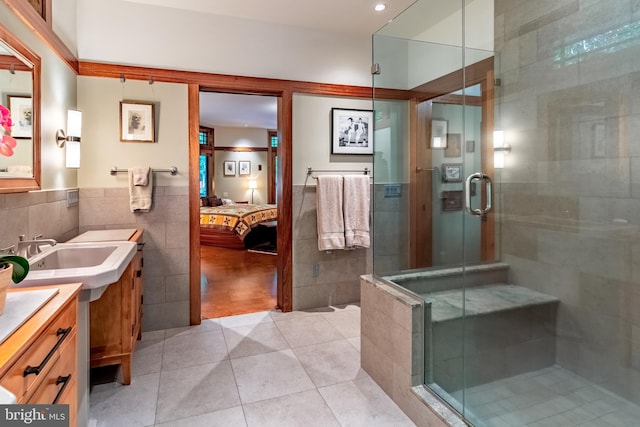 7004 Upper York Rd, New Hope, PA 18938 - bathroom featuring tile walls, connected bathroom, tile patterned flooring, vanity, and a stall shower