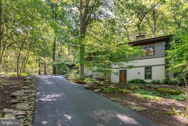 7004 Upper York Rd, New Hope, PA 18938 - view of front of house featuring stucco siding and a wooded view