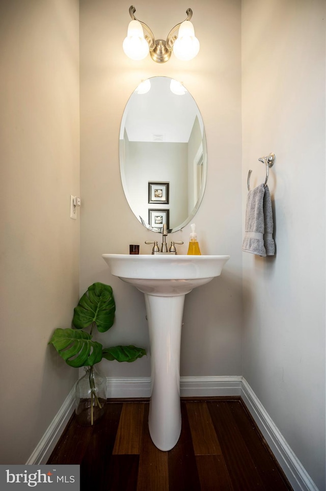 bathroom featuring baseboards and wood finished floors