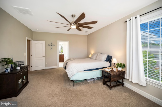 bedroom with light carpet, baseboards, and a ceiling fan