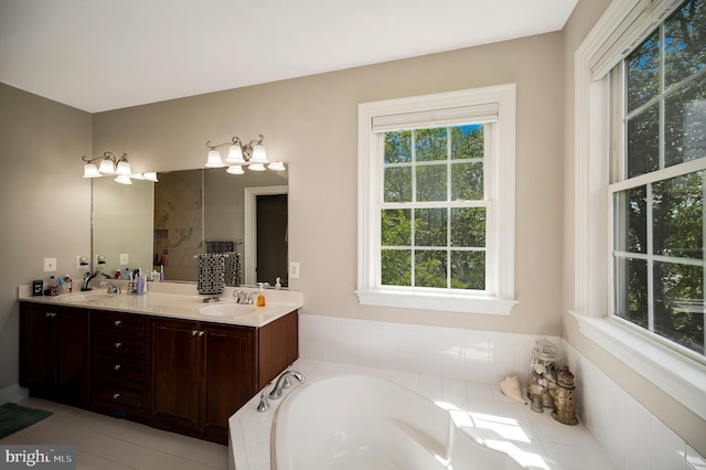 full bath with healthy amount of natural light, a garden tub, double vanity, and tile patterned floors