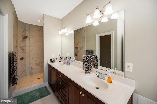 bathroom with a tile shower, double vanity, recessed lighting, and marble finish flooring