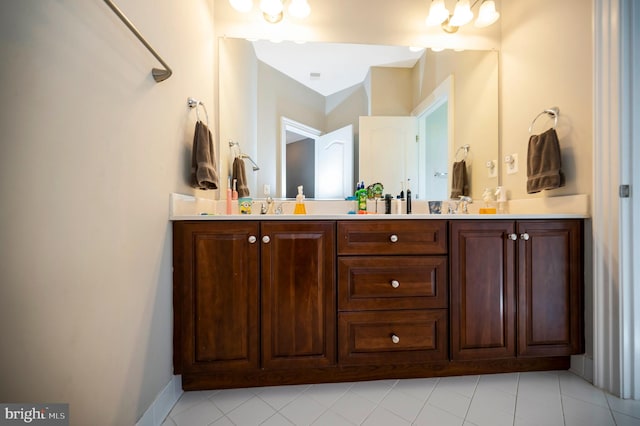 bathroom with tile patterned floors and double vanity