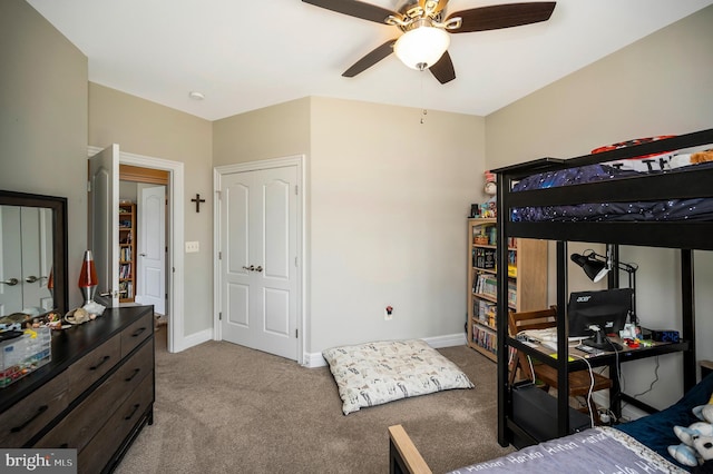 carpeted bedroom featuring baseboards and ceiling fan