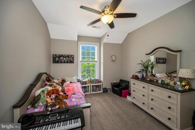 bedroom with carpet flooring, vaulted ceiling, and a ceiling fan