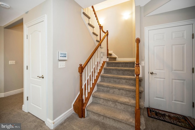 stairs with carpet and baseboards