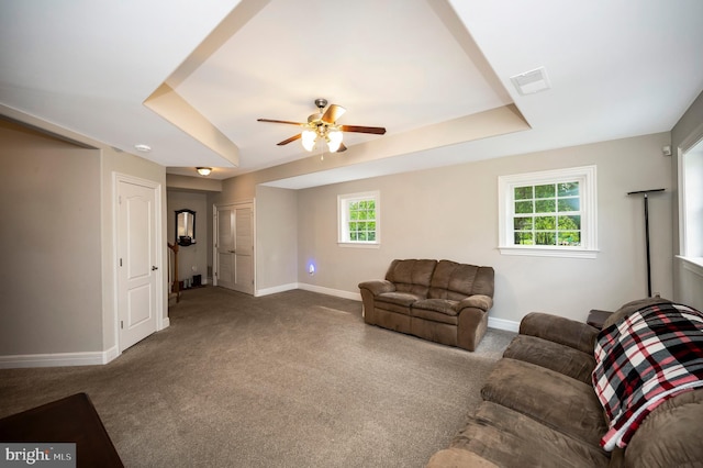 living area with baseboards, ceiling fan, and carpet floors