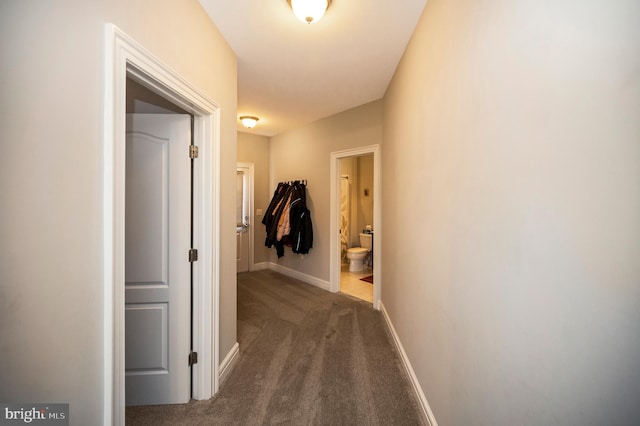 corridor featuring carpet and baseboards