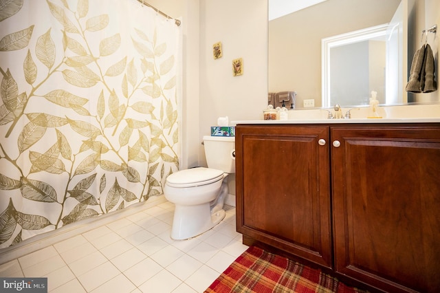full bathroom featuring toilet, vanity, and tile patterned floors