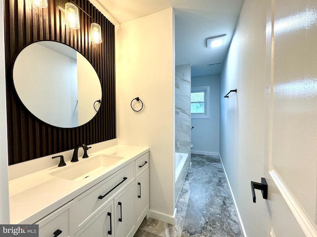 full bath with vanity, baseboards, and marble finish floor
