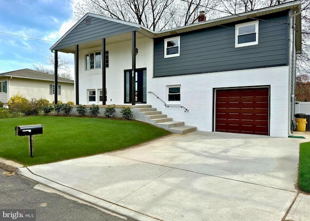 raised ranch featuring a chimney, brick siding, an attached garage, concrete driveway, and a front lawn