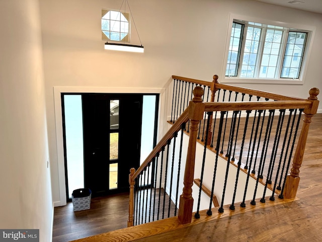 foyer entrance with wood finished floors and baseboards