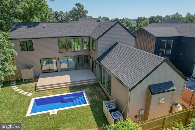 19690 Dunbar St, Rehoboth Beach, DE 19971 - back of house featuring an outdoor pool, a fenced backyard, a wooden deck, and roof with shingles