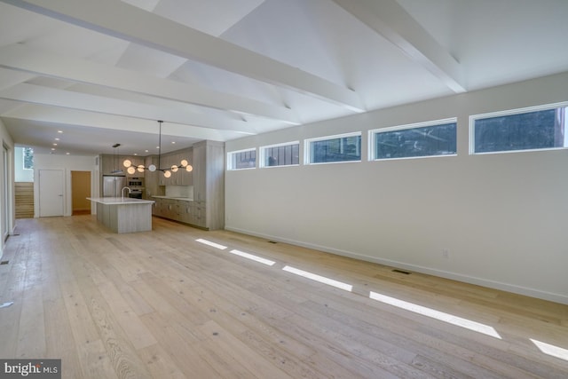 19690 Dunbar St, Rehoboth Beach, DE 19971 - unfurnished living room with a chandelier, light wood-style flooring, healthy amount of natural light, and recessed lighting