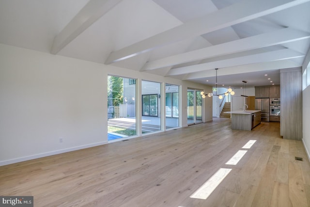 19690 Dunbar St, Rehoboth Beach, DE 19971 - unfurnished living room with a chandelier, light wood finished floors, recessed lighting, and stairway