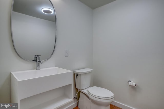 19690 Dunbar St, Rehoboth Beach, DE 19971 - half bath with toilet and wood finished floors