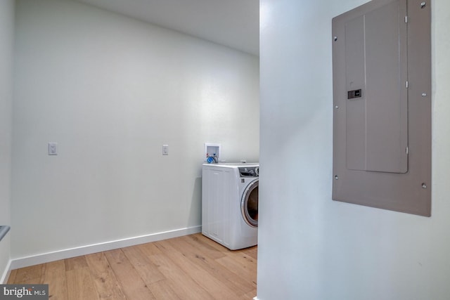 19690 Dunbar St, Rehoboth Beach, DE 19971 - laundry room featuring washer / clothes dryer, electric panel, and light wood finished floors
