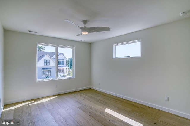 19690 Dunbar St, Rehoboth Beach, DE 19971 - empty room with healthy amount of natural light, hardwood / wood-style floors, a ceiling fan, and a smoke detector