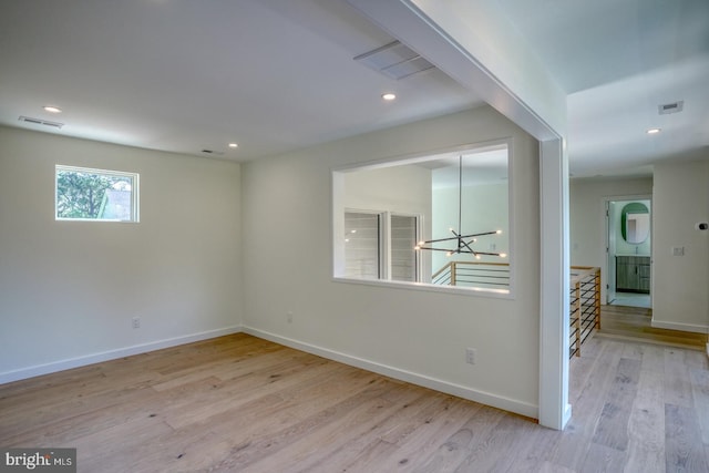 19690 Dunbar St, Rehoboth Beach, DE 19971 - empty room featuring a chandelier, wood finished floors, and recessed lighting