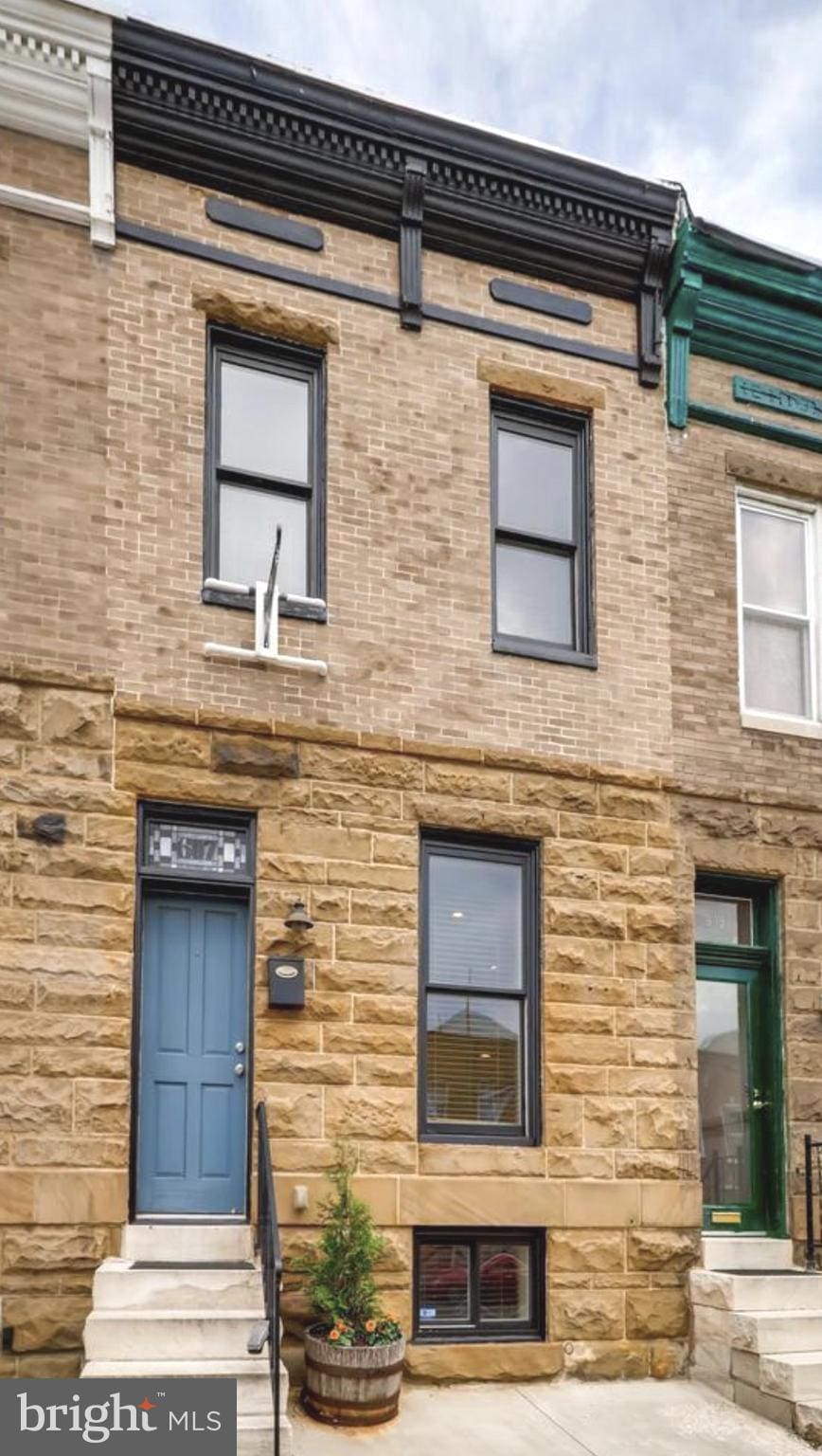 607 S Clinton St, Baltimore, MD 21224 - view of front of house featuring entry steps and stone siding