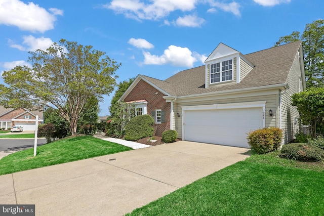 view of front of house with roof with shingles, brick siding, driveway, a garage, and a front yard