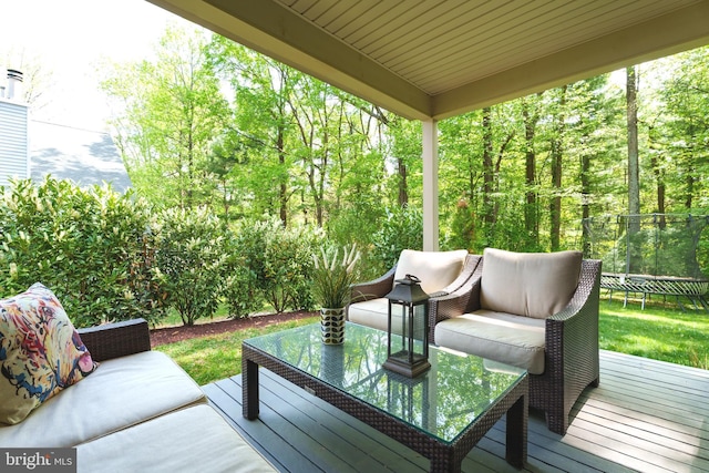 deck with a trampoline and outdoor lounge area