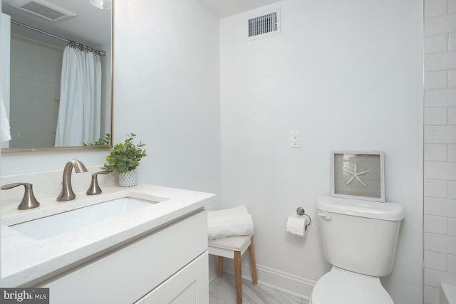 bathroom featuring toilet, visible vents, baseboards, and vanity