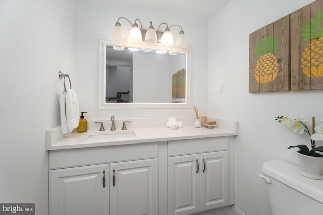 bathroom featuring toilet and vanity
