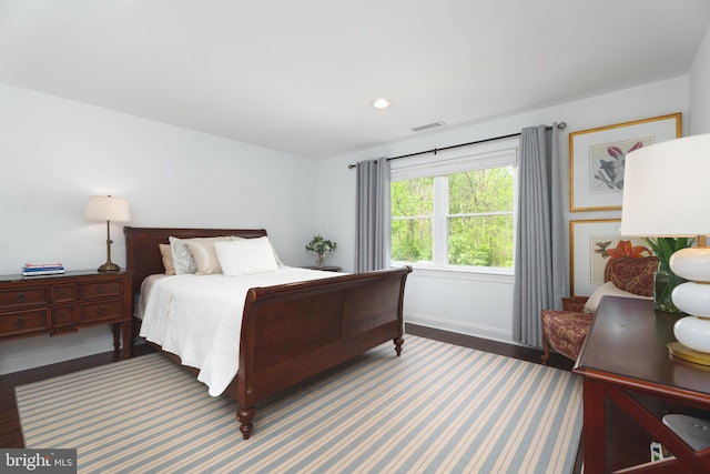 bedroom featuring baseboards, recessed lighting, visible vents, and wood finished floors
