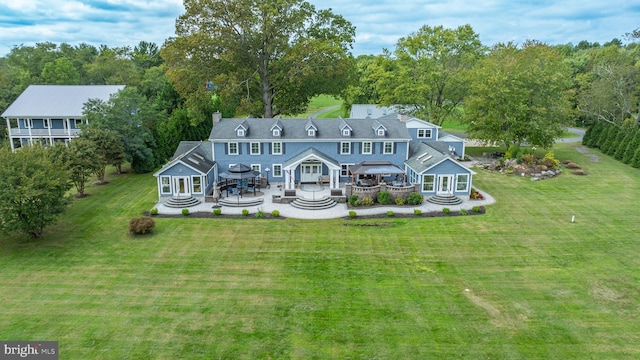 back of property featuring a yard, a wooden deck, and a chimney
