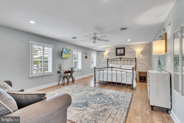 bedroom with light wood-type flooring, visible vents, recessed lighting, an accent wall, and baseboards