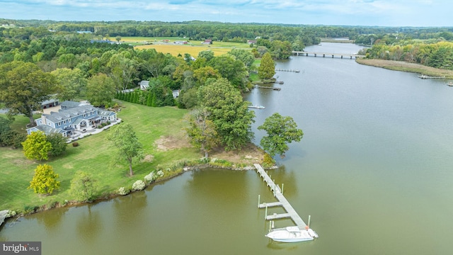 bird's eye view with a forest view and a water view