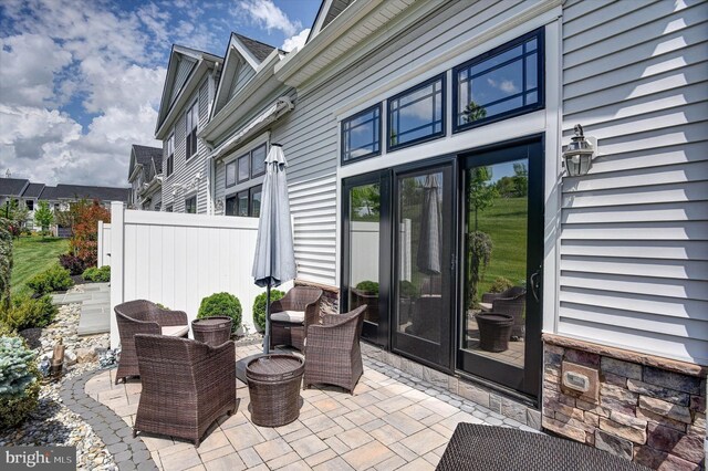 view of patio / terrace featuring fence